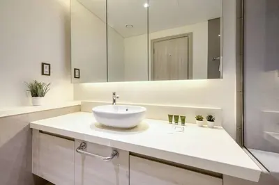 a bathroom with a sink and a mirror at Cozy 1BR Haven in The Cove, Dubai Creek Harbour in Dubai