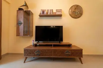a living room with a tv and a coffee table at Fantastic Apartment near Metro and jbr beach in Dubai