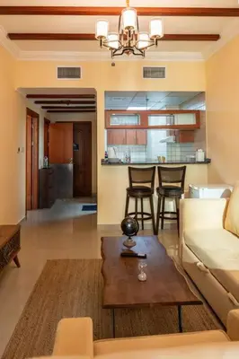 a living room with a couch and a table at Fantastic Apartment near Metro and jbr beach in Dubai