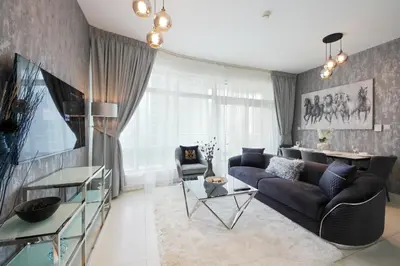 a living room with a couch and a table at Spectacular 1BHK near Dubai Mall in The Lofts East - TrueBleu Homes in Dubai
