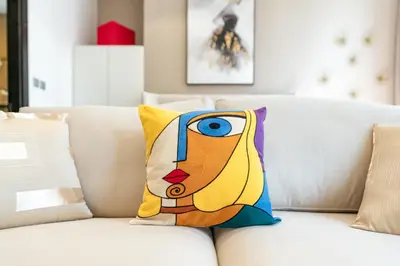 a pillow of a woman on a white couch at Cayan Tower Dubai Marina - By Home Of Choice in Dubai