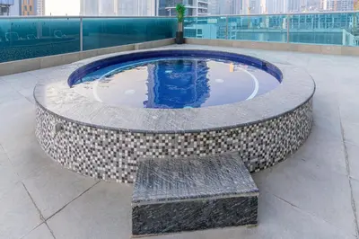 a circular pool with a bench in a building at Modern Studio with Canal View in Business Bay in Dubai