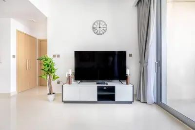 a living room with a flat screen tv on a wall at Luxury 1BR Retreat l 17 Icon Bay, Dubai Creek in Dubai
