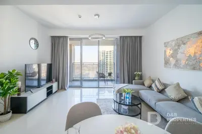 a living room with a couch and a tv at Luxury 1BR Retreat l 17 Icon Bay, Dubai Creek in Dubai