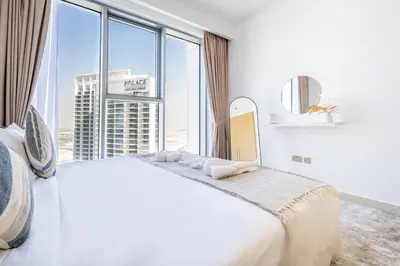 a bedroom with a large white bed with a large window at Luxury 1BR Retreat l 17 Icon Bay, Dubai Creek in Dubai