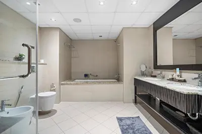 a bathroom with a toilet and a sink and a tub at Full Sea View 1 BR with Lagoon Pool & Beach Access in Dubai