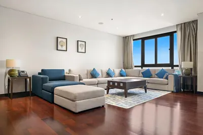 a living room with a couch and a table at Full Sea View 1 BR with Lagoon Pool & Beach Access in Dubai