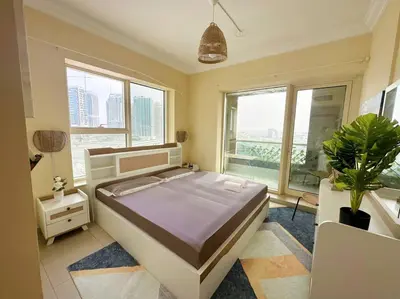 a bedroom with a bed and a large window at Lux 1BR w rooftop pool in Marina near metro, Beach in Dubai