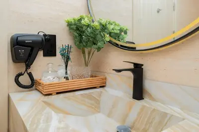a bathroom sink with a phone and a mirror at Dubai Marina - 1BHK Apartment in Dubai