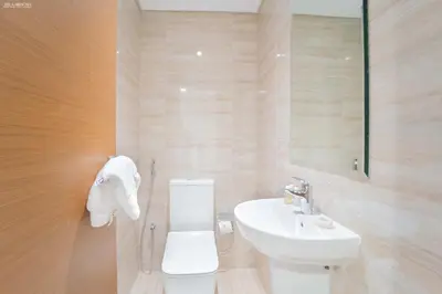 a bathroom with a white toilet and a sink at Fabulous Missoni Designer Building, 3 bedroom plus maid in Dubai