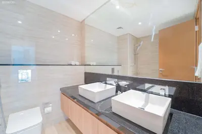 a bathroom with two sinks and a large mirror at Fabulous Missoni Designer Building, 3 bedroom plus maid in Dubai