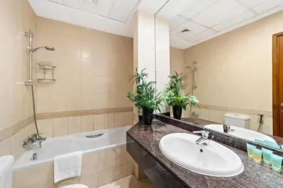 a bathroom with a tub and a sink and a bath tub at Splendid 1BR APT in Dubai Marina in Dubai
