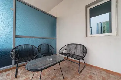 three chairs and a table in a room with a window at Splendid 1BR APT in Dubai Marina in Dubai