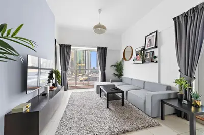 a living room with a couch and a table at Splendid 1BR APT in Dubai Marina in Dubai