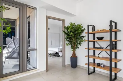 a room with a mirror and a plant on a shelf at Skyline Retreat - South Ridge 2 - Downtown Dubai in Dubai