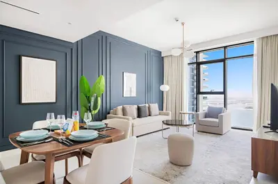 a living room with a table and chairs at Silkhaus Sea & City View 1BDR in Exclusive Neighbourhood in Dubai