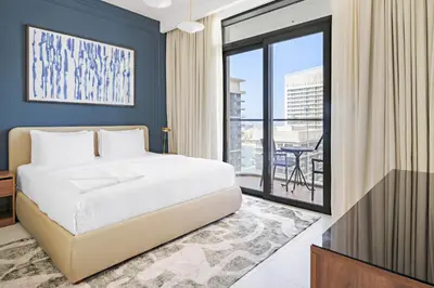 a bedroom with a bed and a balcony at Silkhaus Sea & City View 1BDR in Exclusive Neighbourhood in Dubai