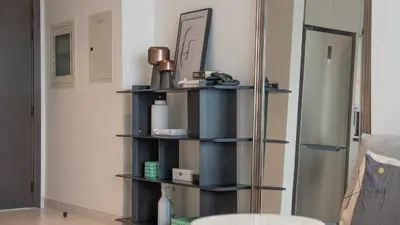 a shelf in a room with a refrigerator at Sky-High 1BR RetreatMarina VistaEmaar Beachfront in Dubai