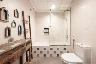 a bathroom with a tub and a toilet and a shower at Apartment KOYO in the heart of JBR Beach - 3BDR in Dubai