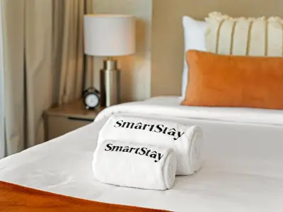 a hotel room with two towels on a bed at SmartStay at Zaya Hameni - Modern Luxury Apartments - Unique in JVC in Dubai