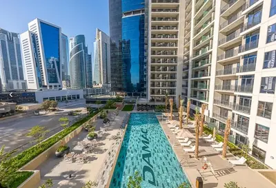 an overhead view of a pool in a city with tall buildings at 1BR Apartment in Zada Tower Business Bay - Close to Metro in Dubai