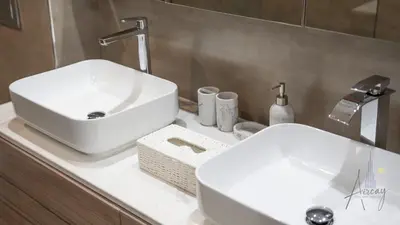 a bathroom with two white sinks and a mirror at Top-Floor Luxury 2BR with Stunning Marina View in Dubai