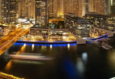 a view of a city at night with lights at Panoramic 1BR Stunning Marina Views Near JBR Beach by Maxx Value Homes in Dubai