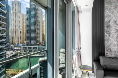 a balcony with a view of the water and buildings at Panoramic 1BR Stunning Marina Views Near JBR Beach by Maxx Value Homes in Dubai