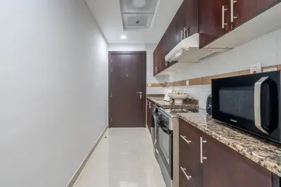 a kitchen with a microwave oven and a stove at GuestReady - A Dream Getaway at Business Bay in Dubai