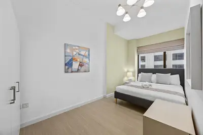 a bedroom with a large bed and a window at Prime Spacious 5 plus 1 BR Apt on JBR Beach near Metro ,Walk to The Mall, Dining & Entertainment - By Sunkissed Holiday Homes in Dubai