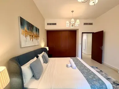 a bedroom with a large bed and a couch at Prime Specious 4 BR Apt on JBR Beach near Metro, Walk to The Mall, Dining & Entertainment - By Sunkissed Holiday Homes in Dubai