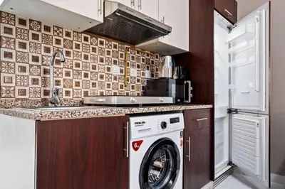 a kitchen with a washer and a washing machine at Hidden Gem - Comfort And Family Friendly in Dubai