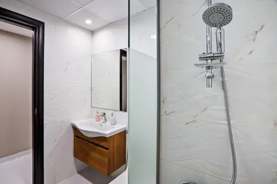 a bathroom with a shower and a sink at Hidden Gem - Comfort And Family Friendly in Dubai