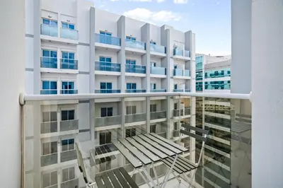 a view of a building with chairs in front of it at Hidden Gem - Comfort And Family Friendly in Dubai