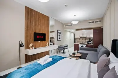 a bedroom with a large bed and a living room at Hidden Gem - Comfort And Family Friendly in Dubai