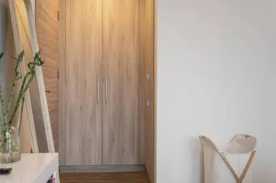 a closet with a wooden door in a room at DAYF-SOL Luxury Living in Business Bay in Dubai