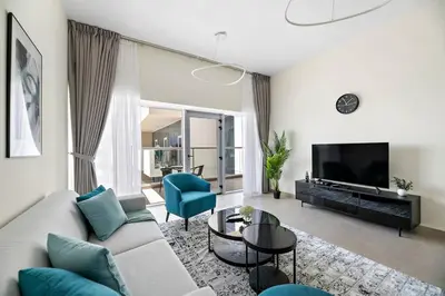 a living room with a couch and a tv at Stylish 1 BR in Al Furjan in Dubai