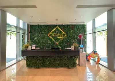 a lobby with a green wall with a sign on it at Dubai Marina Residences, Studio with Balcony Connected to Marina Mall in Dubai