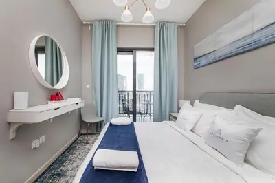 a bedroom with a large bed and a mirror at Zada Tower 1BR with amazing Dubai Canal view in Dubai
