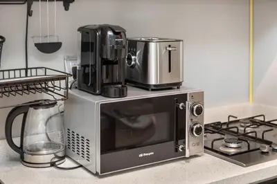 a microwave oven with a coffee maker on top of it at Zada Tower 1BR with amazing Dubai Canal view in Dubai