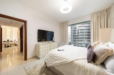a bedroom with a large bed and a large window at EDEN'S Homes & Villas - Standpoint Residences in Dubai
