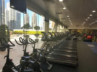 a gym with rows of exercise bikes in a building at FIRST CLASS 2BR with Exquisite Full Marina View in Dubai