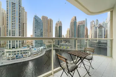 a balcony with two chairs and a view of a city at FIRST CLASS 2BR with Exquisite Full Marina View in Dubai