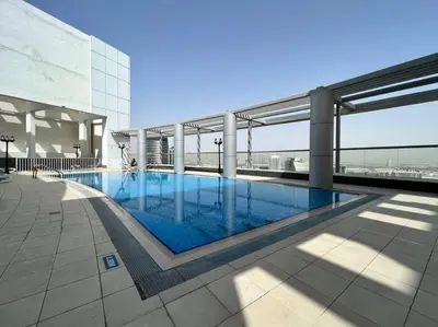 a swimming pool on the roof of a building at Stylish Studio Walk to Dubai Mall & Burj Khalifa with Pool, Gym & Balcony in Dubai