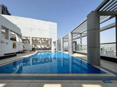 a large swimming pool on the roof of a building at Stylish Studio Walk to Dubai Mall & Burj Khalifa with Pool, Gym & Balcony in Dubai