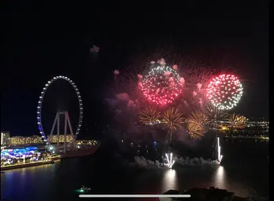a fireworks display with a ferris wheel in the background at Amazing Sea View 2 bedroom Full Apartment in Dubai