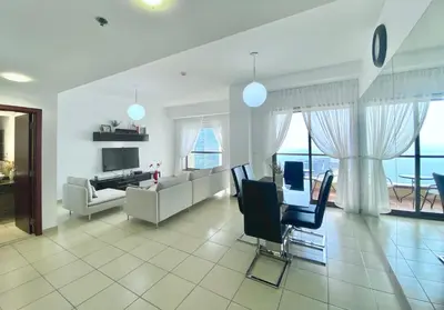 a living room with a couch and a table at Amazing Sea View 2 bedroom Full Apartment in Dubai