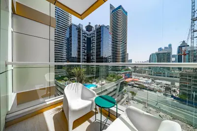 a balcony with a view of a city skyline at 1BR + maid room Apartment in Downtown Dubai in Dubai