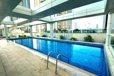 a large swimming pool inside of a building at 1BR + maid room Apartment in Downtown Dubai in Dubai
