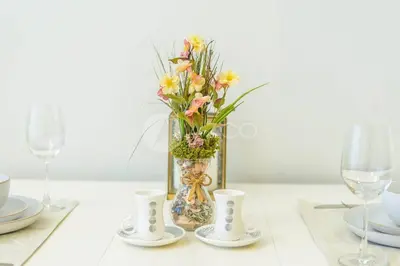 a table with a vase with flowers in it at Elegant Studio at Aykon City Tower - C in Dubai